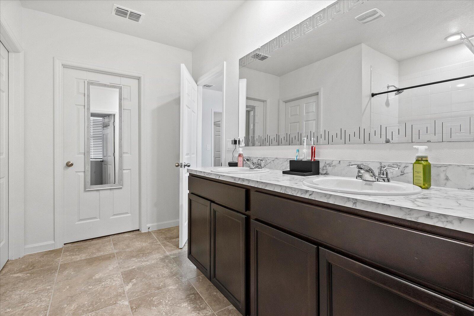 1671 Saxton Road Cocoa, FL 32926 - Photo 24 of 39 a bathroom with a sink and a mirror