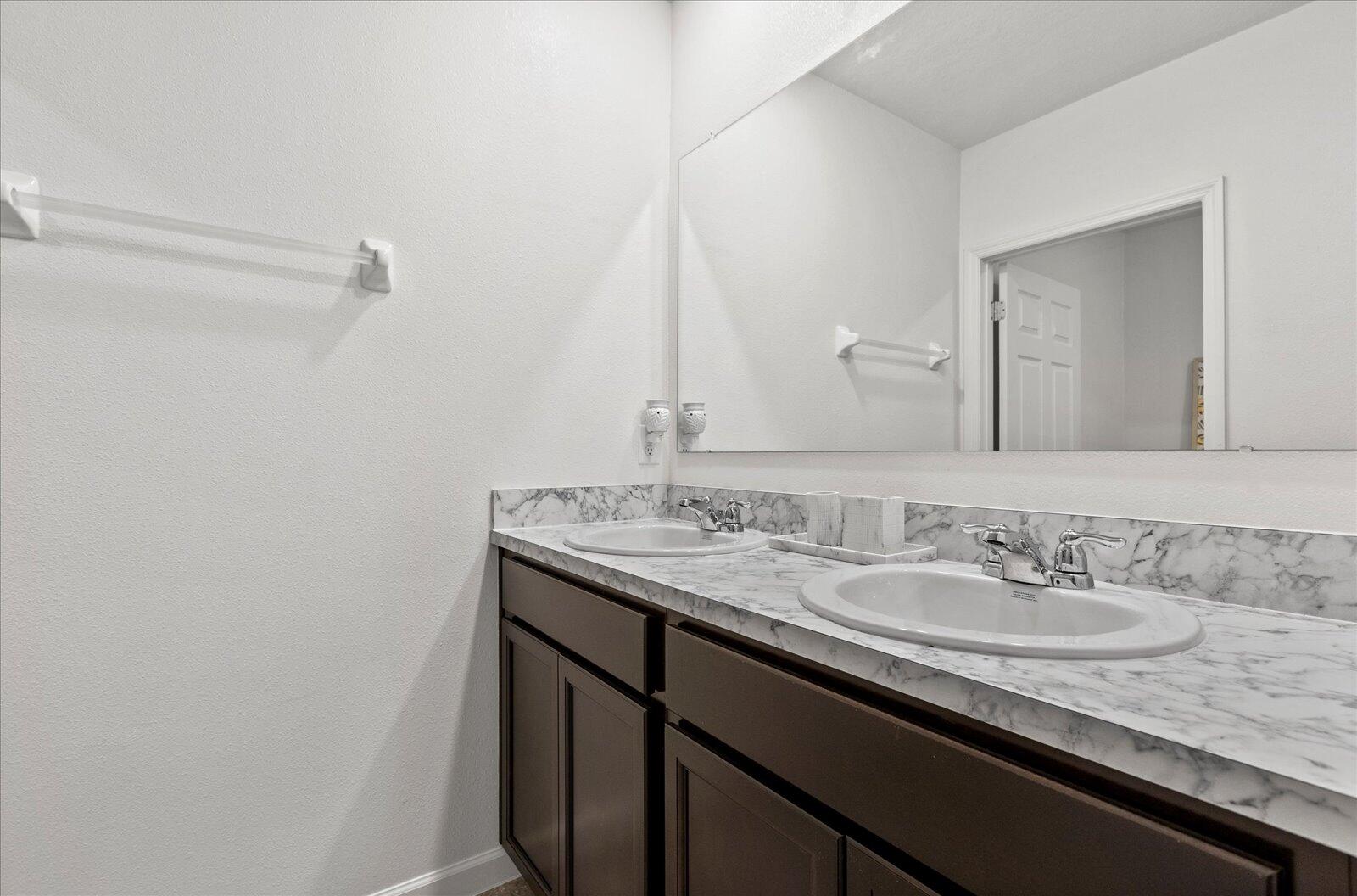 1671 Saxton Road Cocoa, FL 32926 - Photo 30 of 39 a bathroom with a granite countertop sink and a mirror