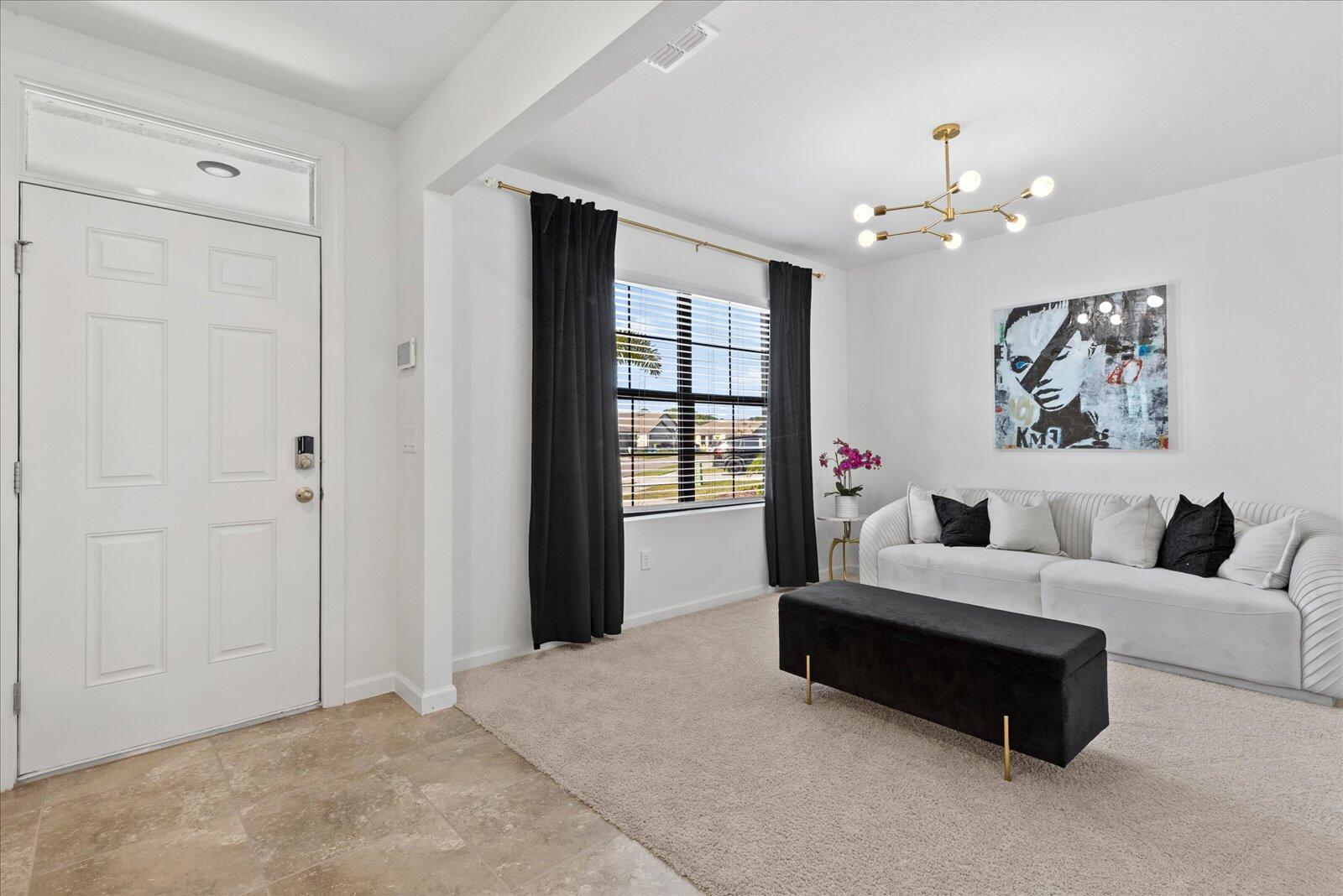 1671 Saxton Road Cocoa, FL 32926 - Photo 3 of 39 a spacious bedroom with a bed couch and window