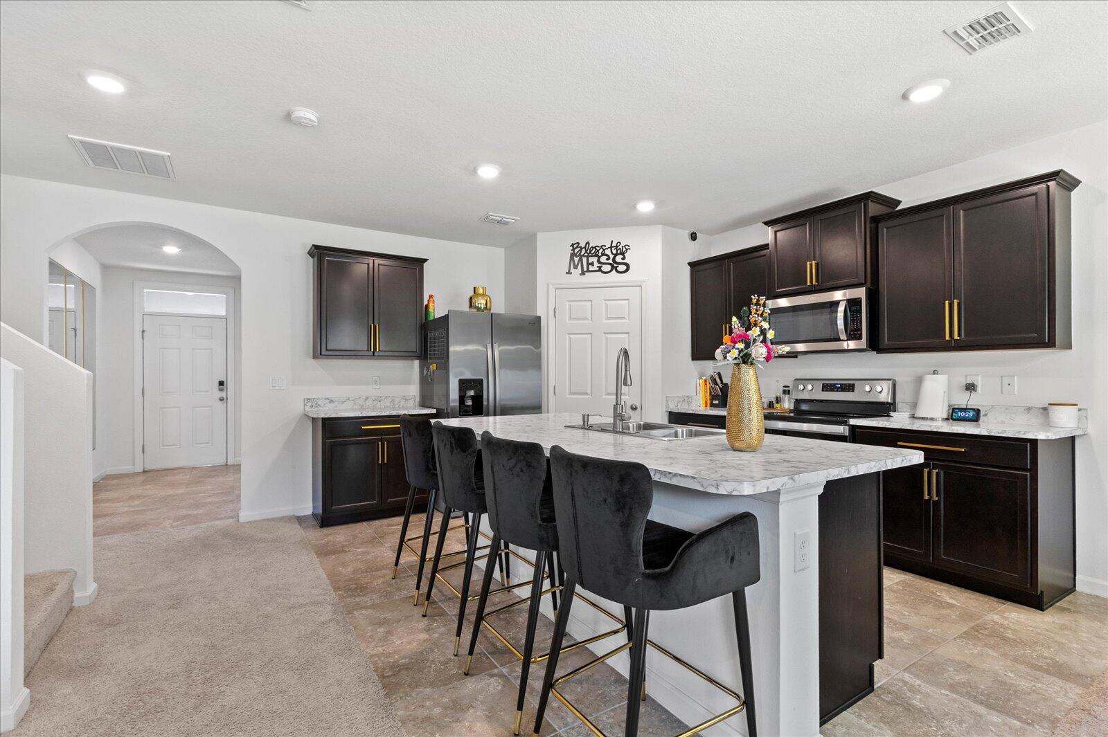 1671 Saxton Road Cocoa, FL 32926 - Photo 5 of 39 a kitchen with cabinets a sink and stainless steel appliances