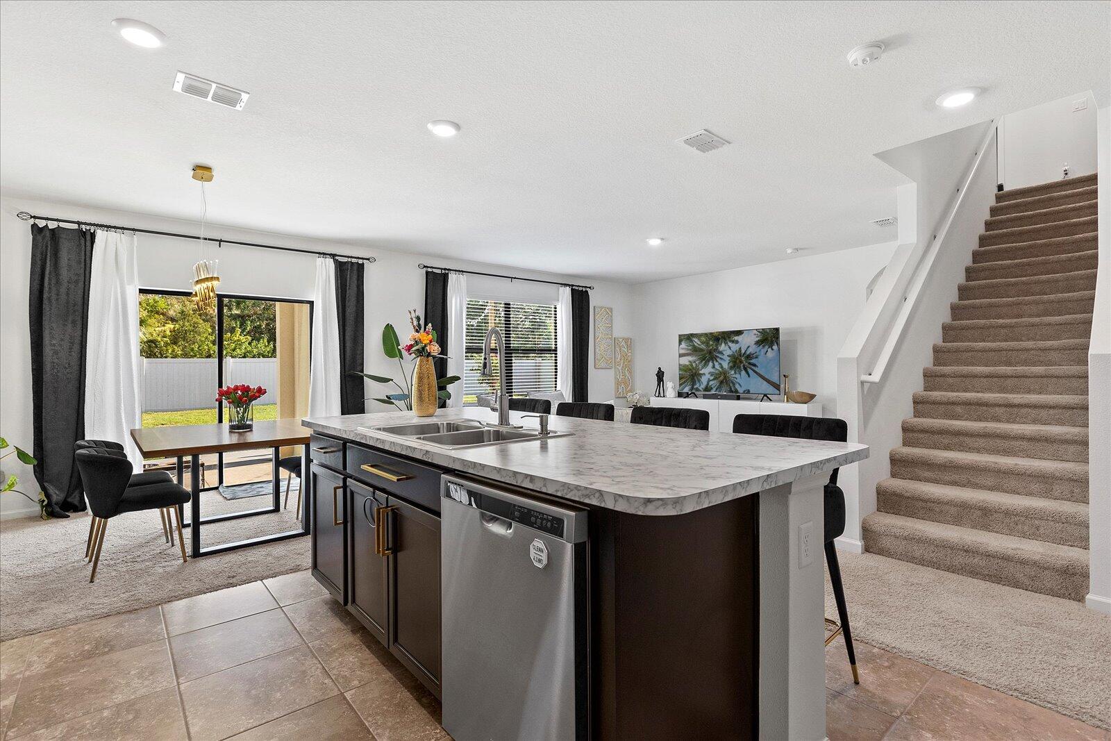 1671 Saxton Road Cocoa, FL 32926 - Photo 8 of 39 a kitchen with a sink a counter top space and living room view