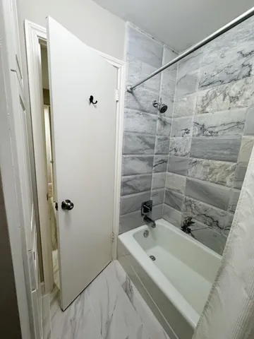 a bathroom with a bathtub and shower