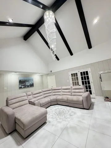 a living room with furniture and a ceiling fan