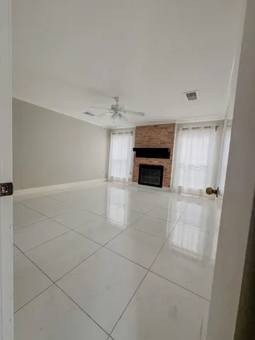 a view of empty room with a fireplace