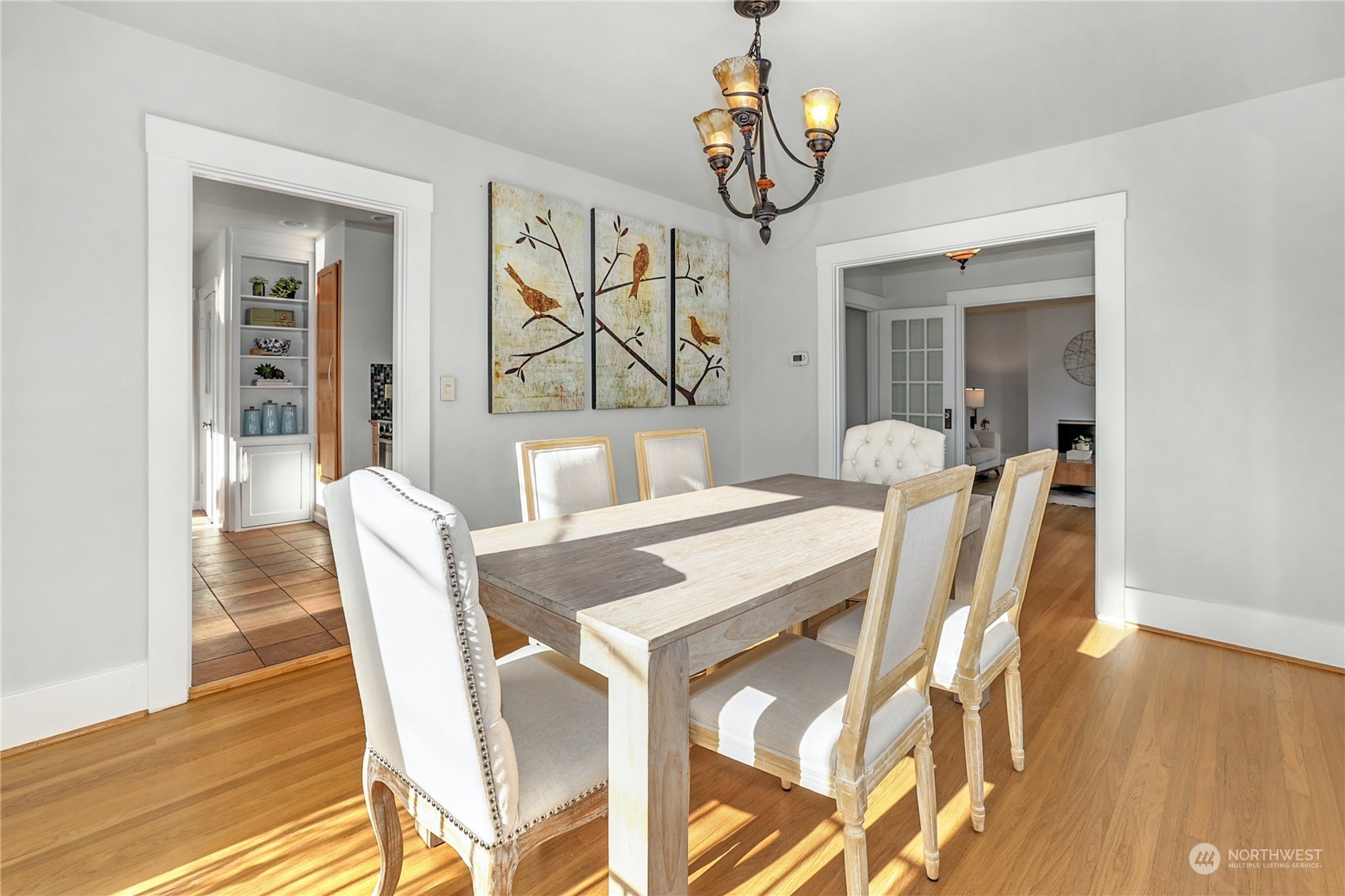 3603 Bagley Avenue North Seattle, WA 98103 - Photo 11 of 38 a view of a dining room with furniture wooden floor and chandelier