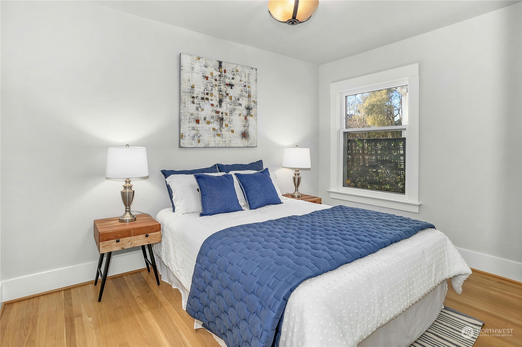 3603 Bagley Avenue North Seattle, WA 98103 - Photo 15 of 38 a bedroom with a bed and painting on the wall