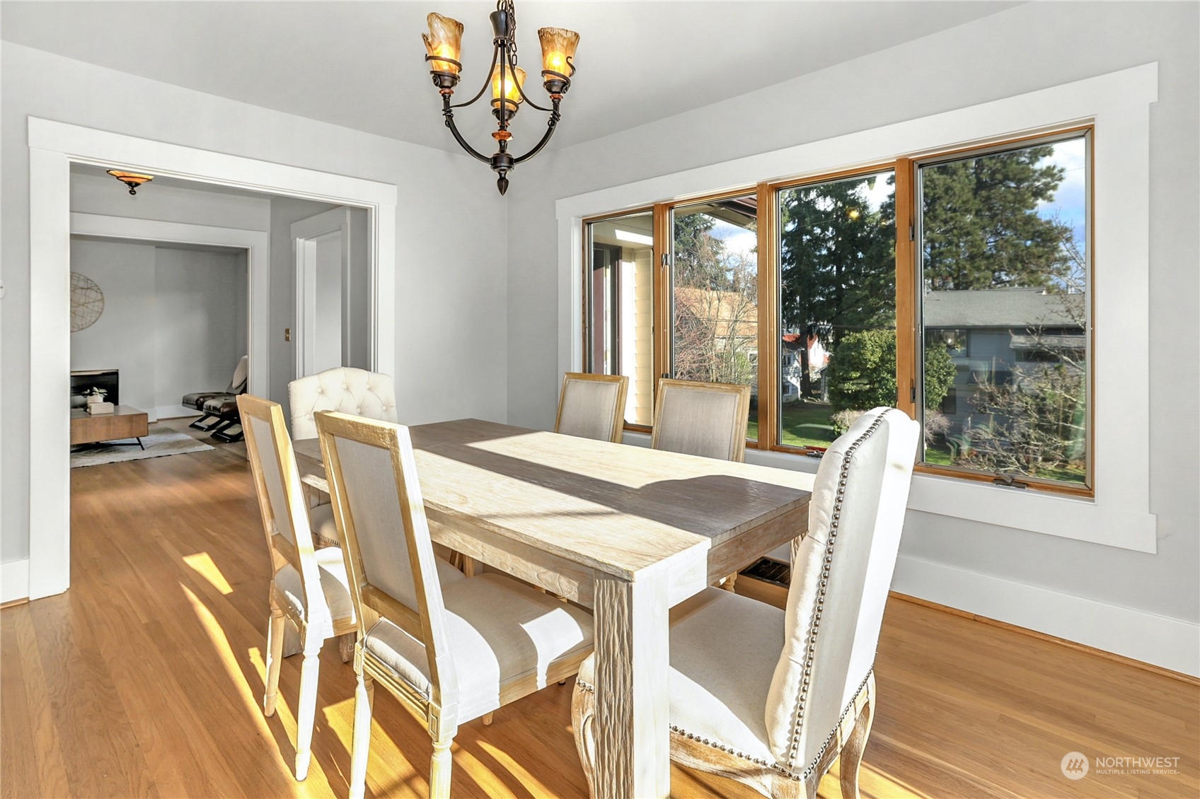 3603 Bagley Avenue North Seattle, WA 98103 - Photo 10 of 38 a view of a dining room with furniture wooden floor and a chandelier