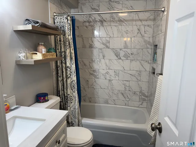 a bathroom with a sink toilet and shower