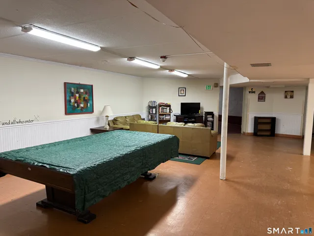 a living room with kitchen furniture and a table