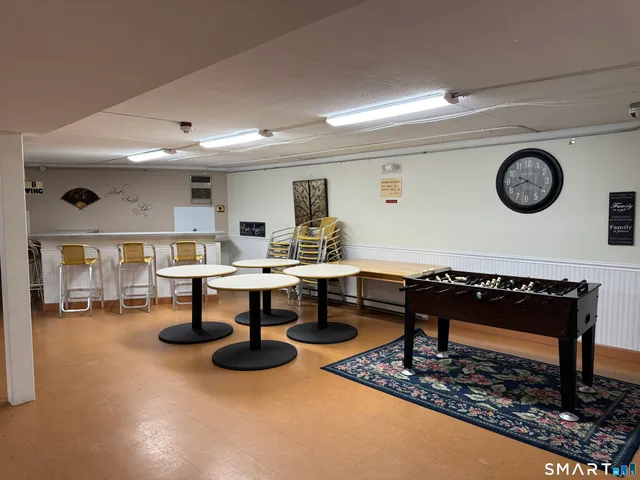 a living room with furniture a table and a clock