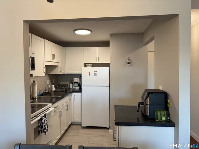a white refrigerator freezer sitting in a kitchen