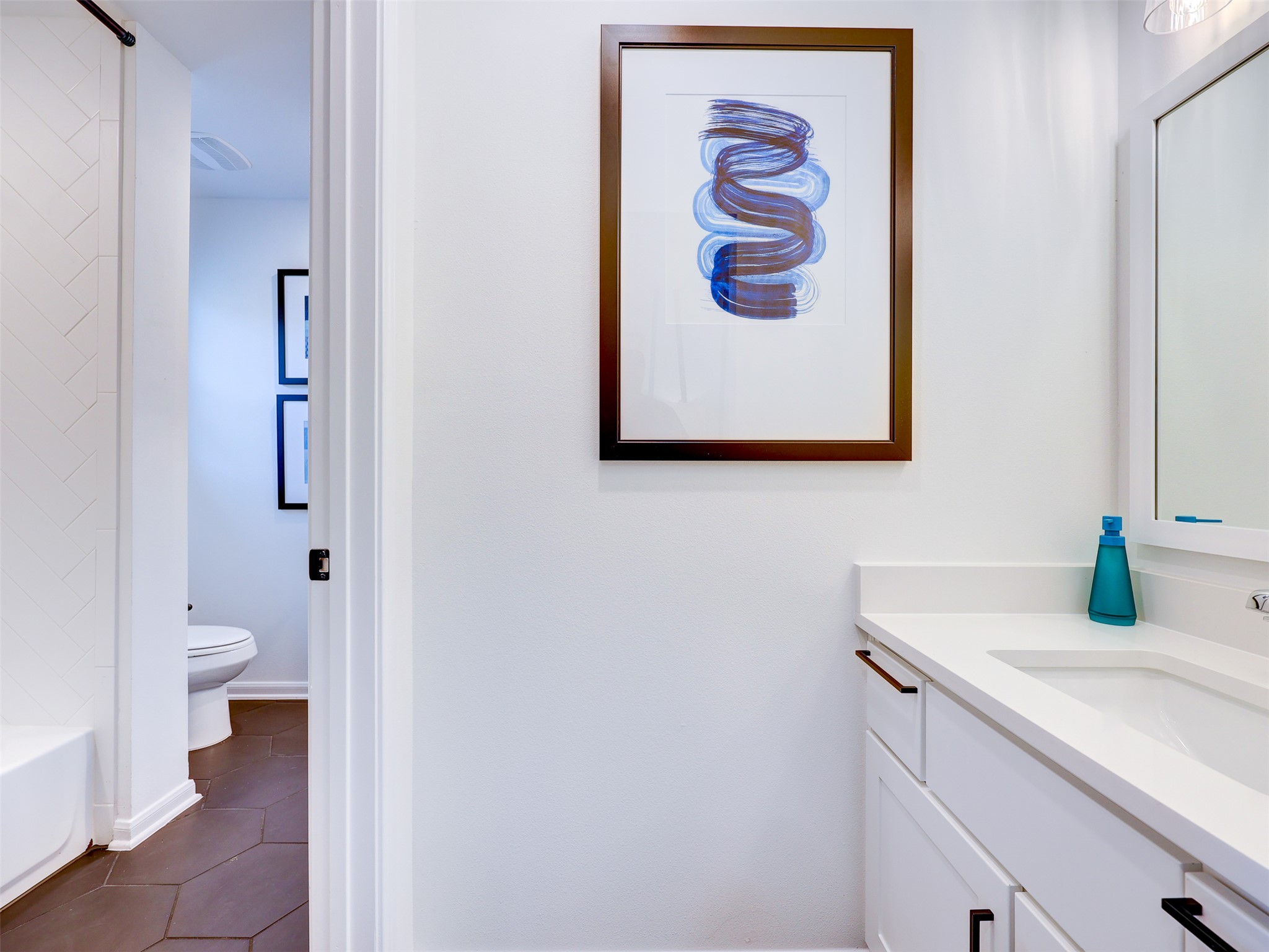 6220 Bower Well Road Austin, TX 78738 - Photo 24 of 28 A well-appointed bathroom vanity with a clean white countertop and modern fixtures.
