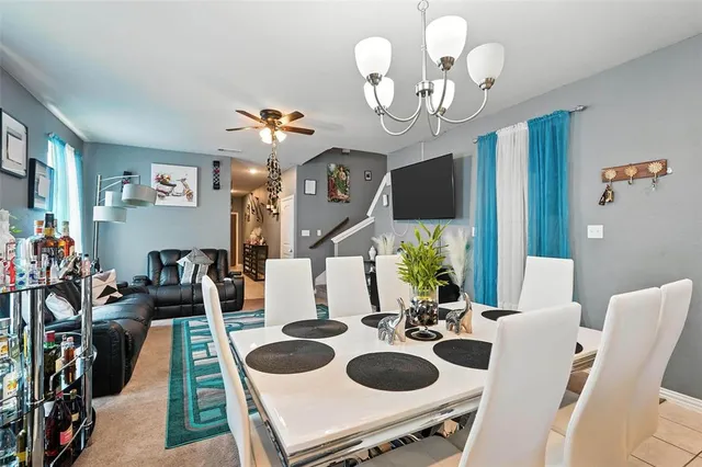 a view of a dining room with furniture and chandelier