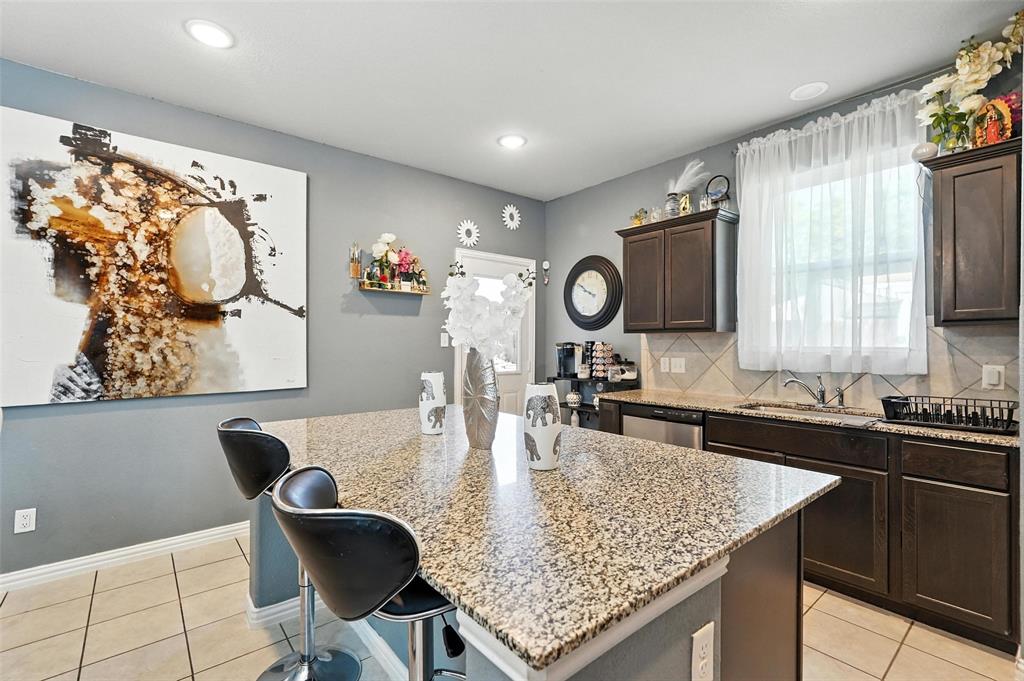 314 Frank Street Terrell, TX 75160 - Photo 15 of 40 a kitchen with granite countertop a sink and a stove