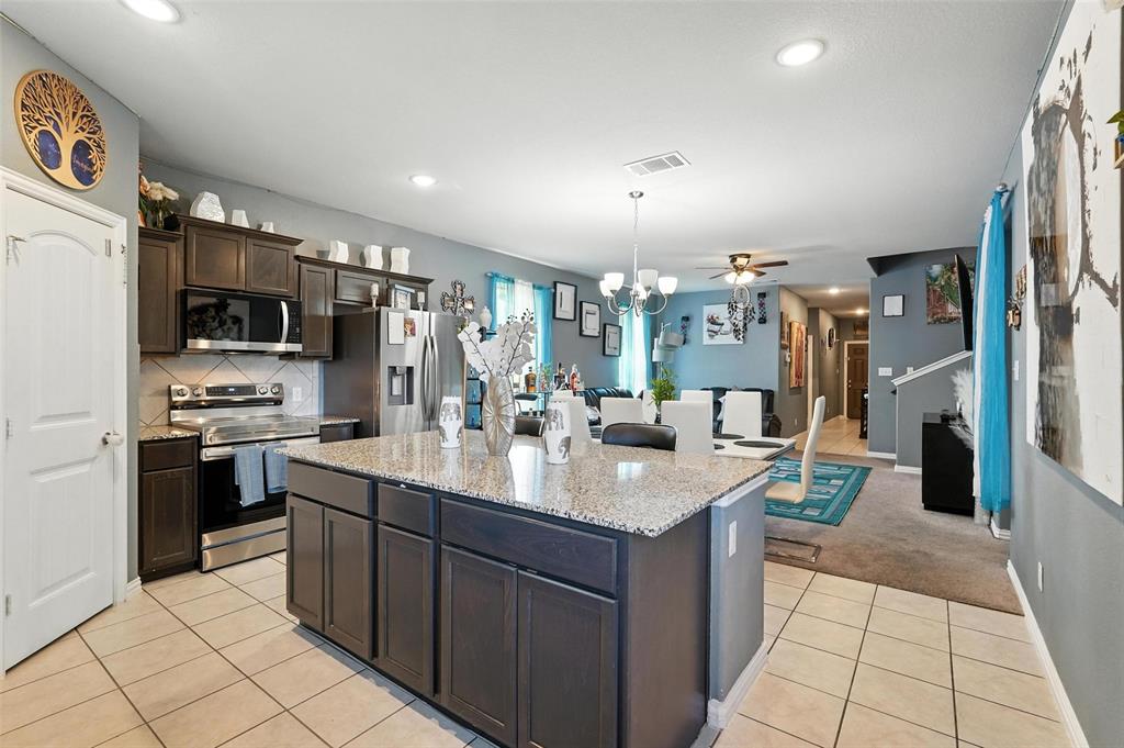 314 Frank Street Terrell, TX 75160 - Photo 16 of 40 a large kitchen with stainless steel appliances a large counter top a stove a chimney a sink and dishwasher