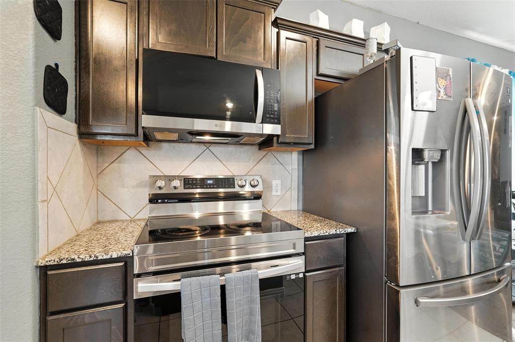 314 Frank Street Terrell, TX 75160 - Photo 18 of 40 a kitchen with stainless steel appliances granite countertop a refrigerator and a microwave