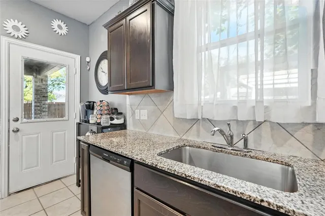 a kitchen with stainless steel appliances granite countertop a refrigerator and a microwave