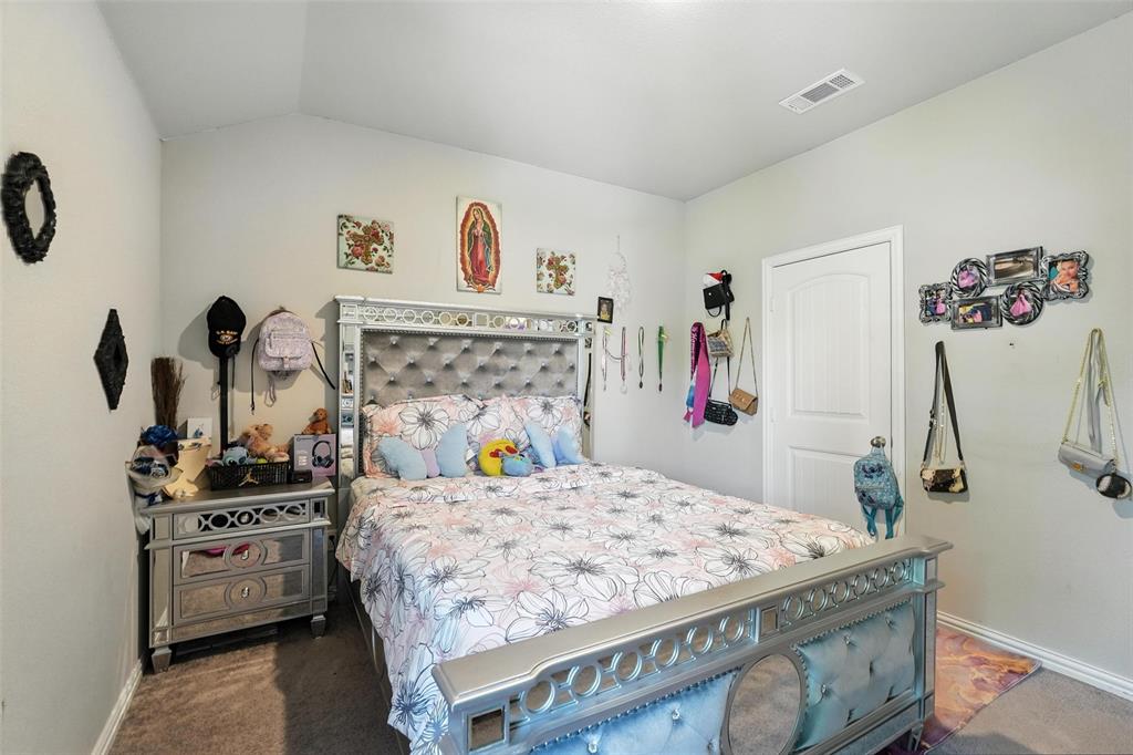 314 Frank Street Terrell, TX 75160 - Photo 25 of 40 a bedroom with a bed and a refrigerator