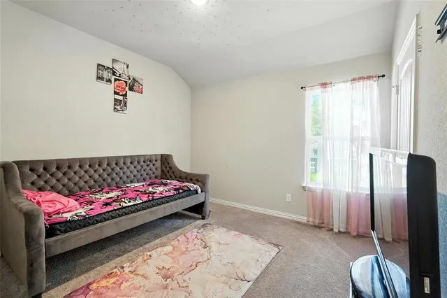 a bedroom with a bed and a painting on the wall