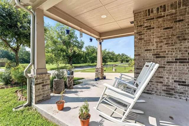 a view of deck with furniture and garden