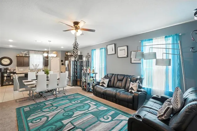 a living room with furniture and a chandelier