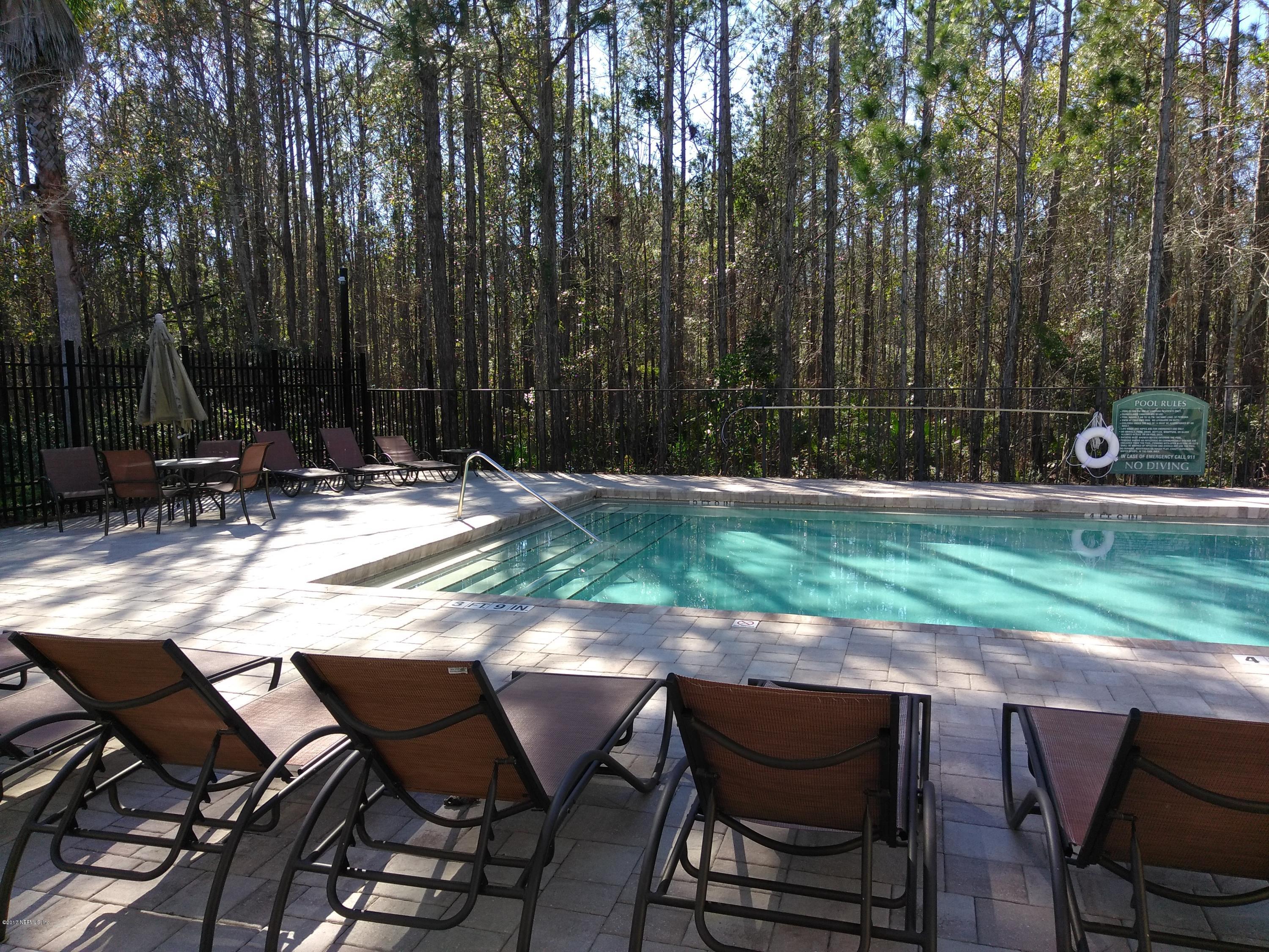 1717 County Road 220, Unit 1908 Fleming Island, FL 32003 - Photo 12 of 12 a backyard of a house with barbeque oven table and chairs