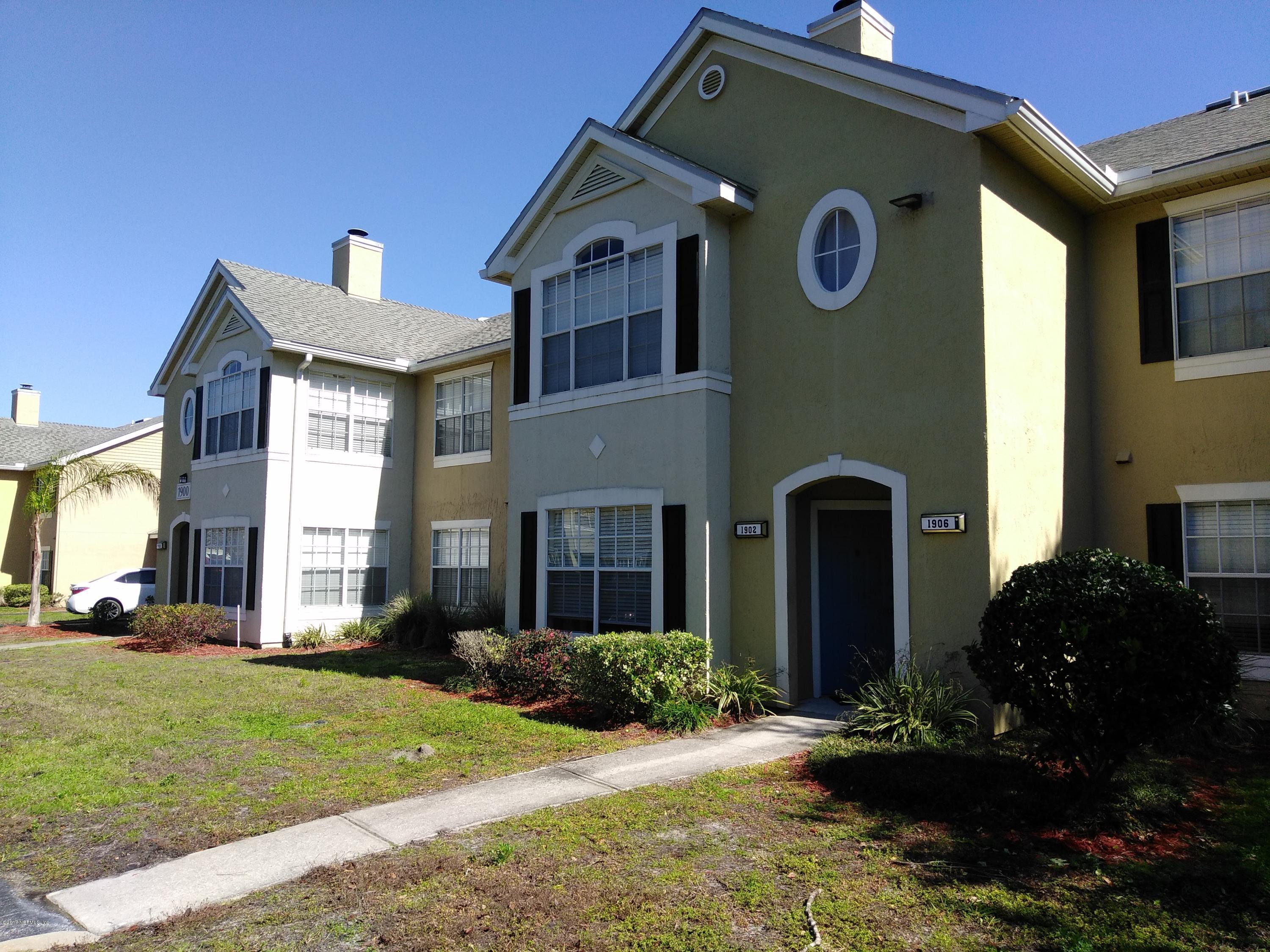 1717 County Road 220, Unit 1908 Fleming Island, FL 32003 - Photo 2 of 12 a front view of a house with garden