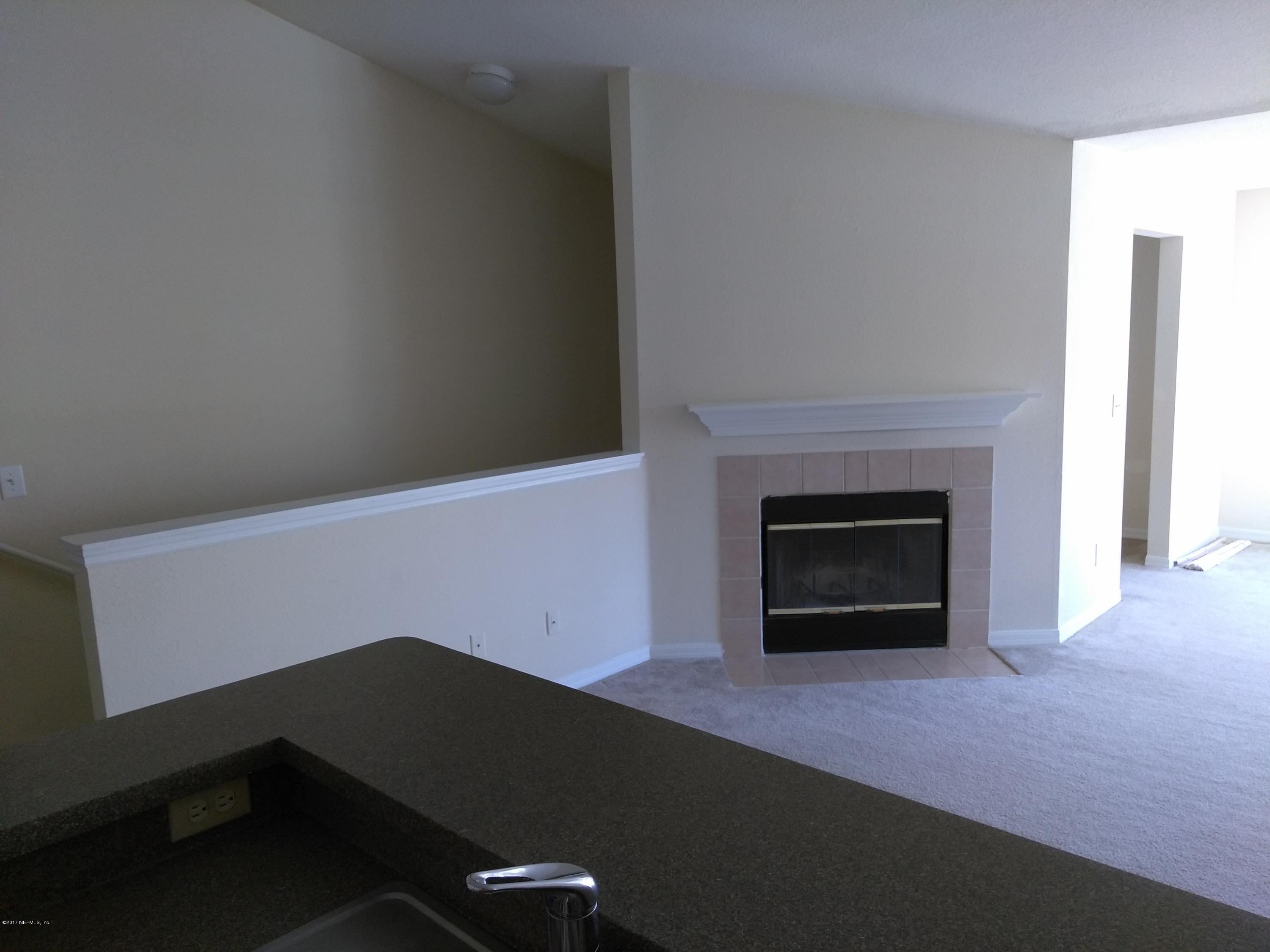 1717 County Road 220, Unit 1908 Fleming Island, FL 32003 - Photo 3 of 12 a living room with a fireplace