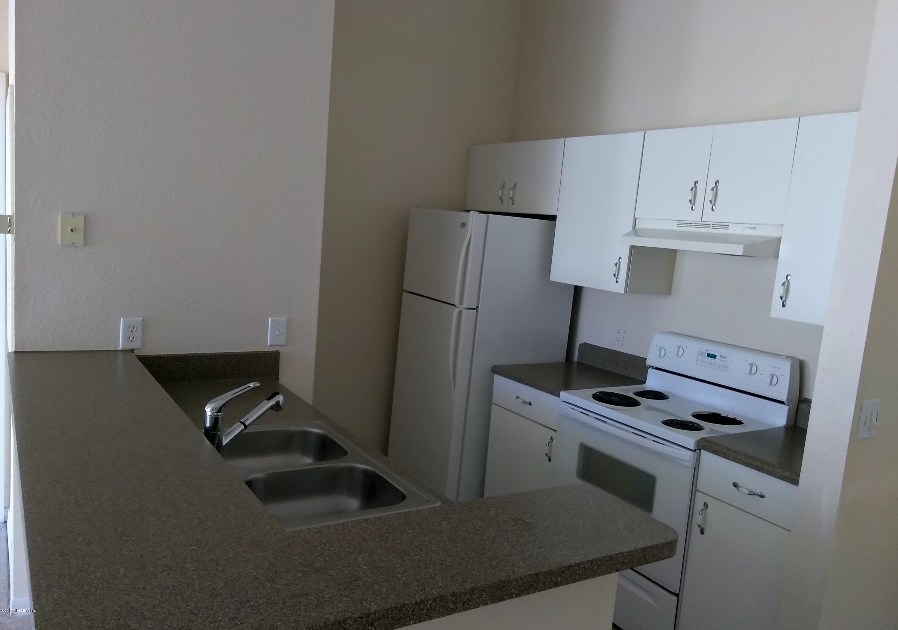 1717 County Road 220, Unit 1908 Fleming Island, FL 32003 - Photo 4 of 12 a kitchen with cabinets and appliances
