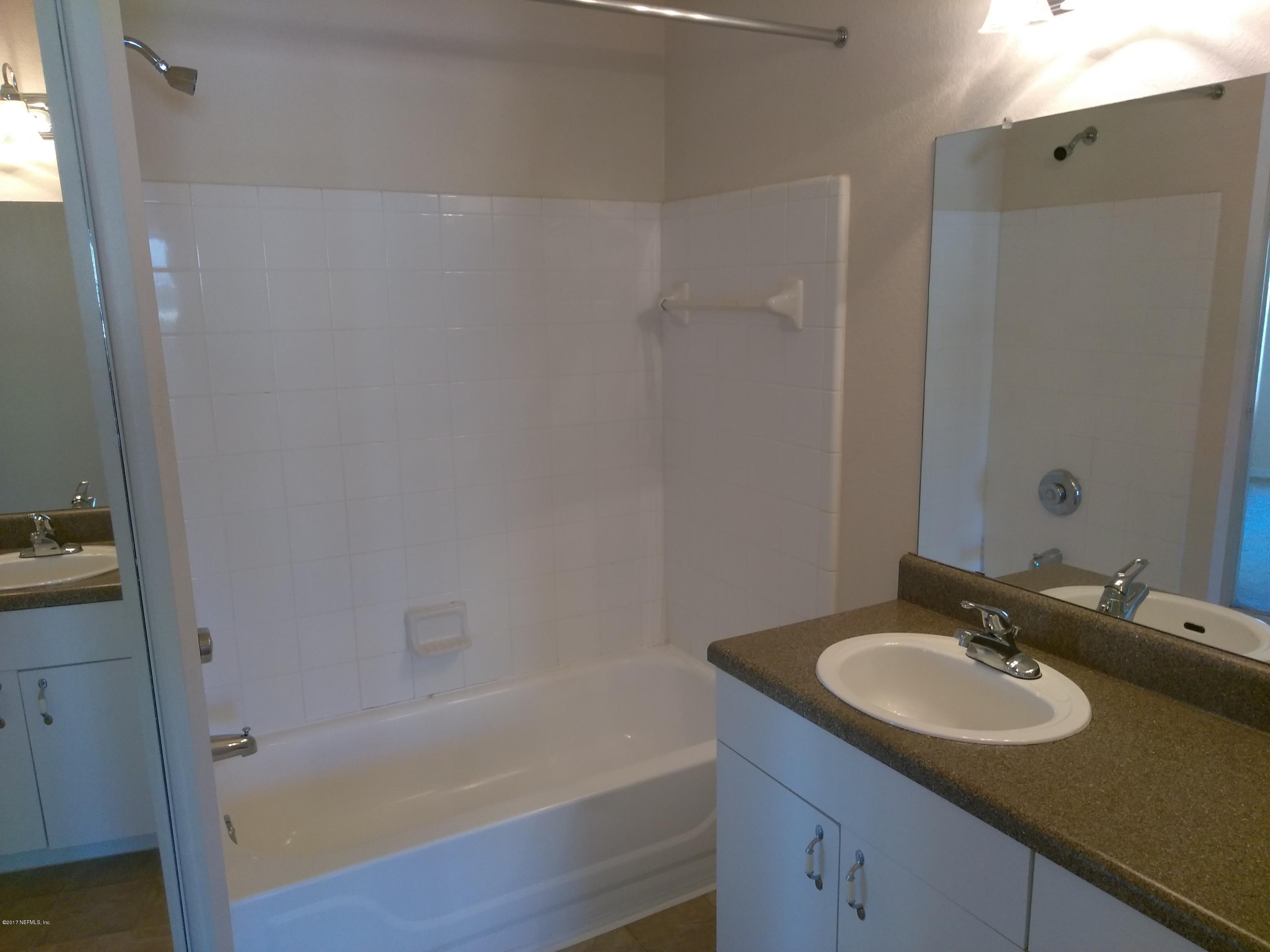 1717 County Road 220, Unit 1908 Fleming Island, FL 32003 - Photo 5 of 12 a bathroom with a sink and a mirror