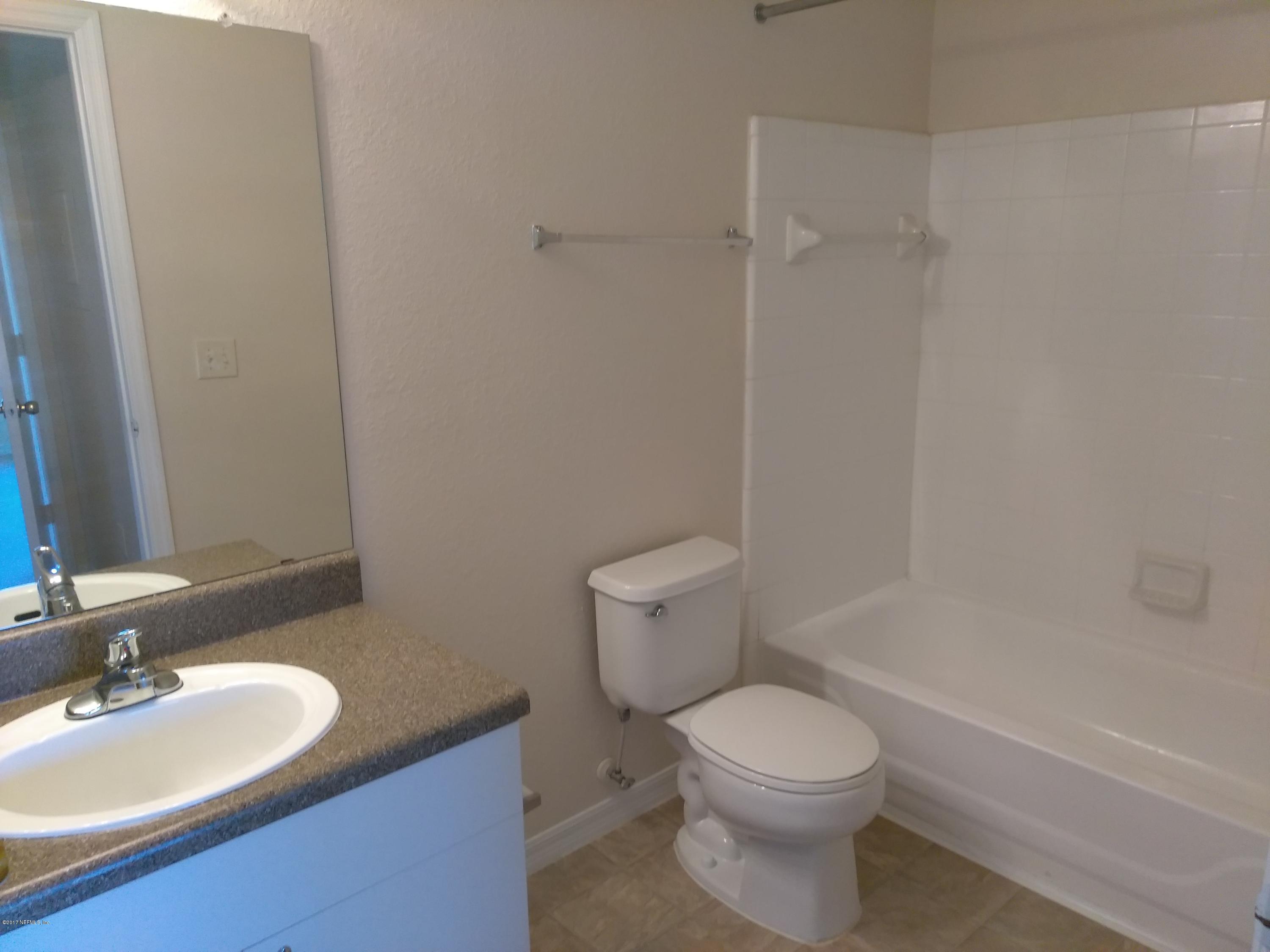 1717 County Road 220, Unit 1908 Fleming Island, FL 32003 - Photo 6 of 12 a bathroom with a sink a toilet and shower