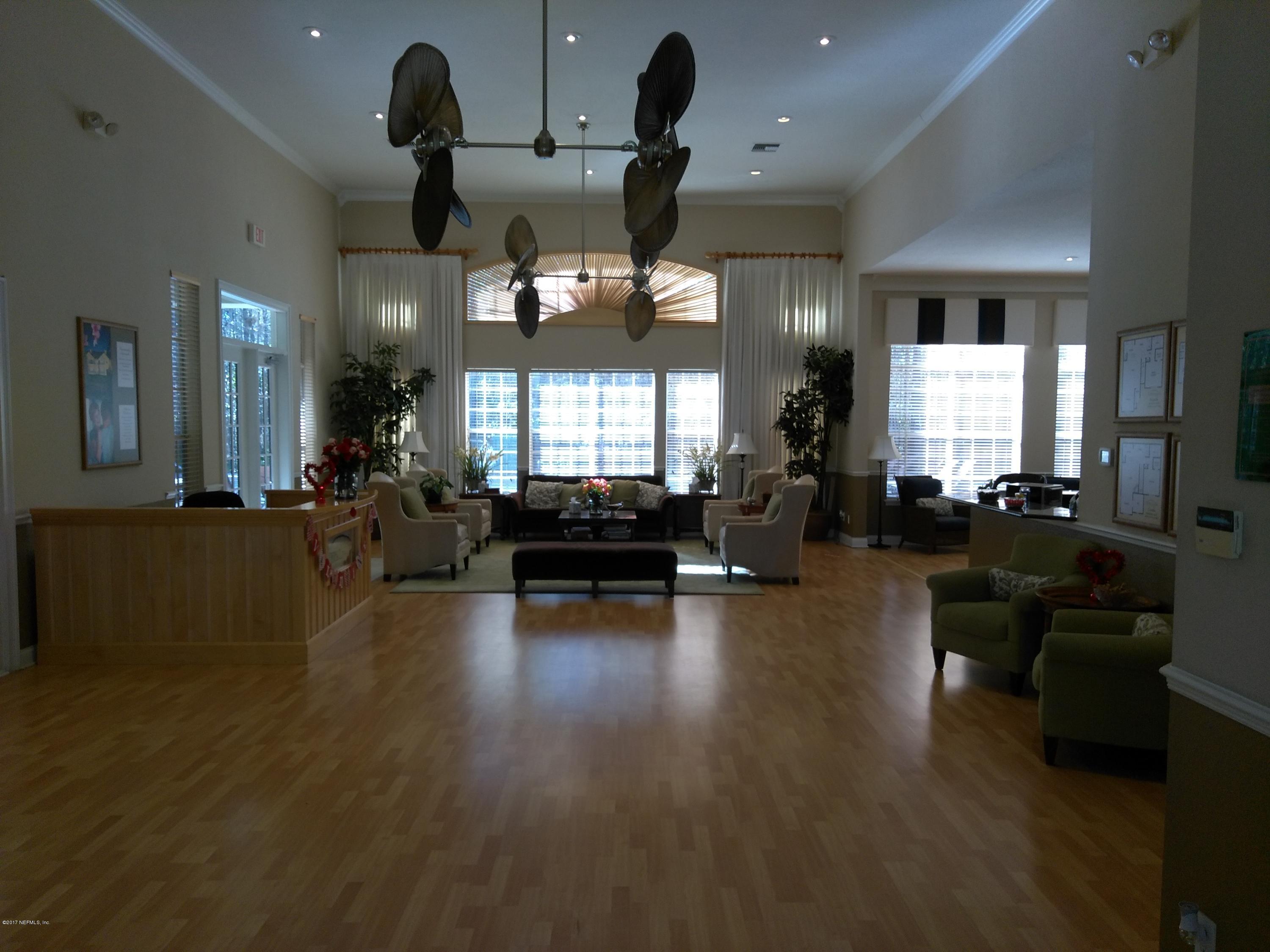 1717 County Road 220, Unit 1908 Fleming Island, FL 32003 - Photo 9 of 12 a living room with fireplace furniture and a large window