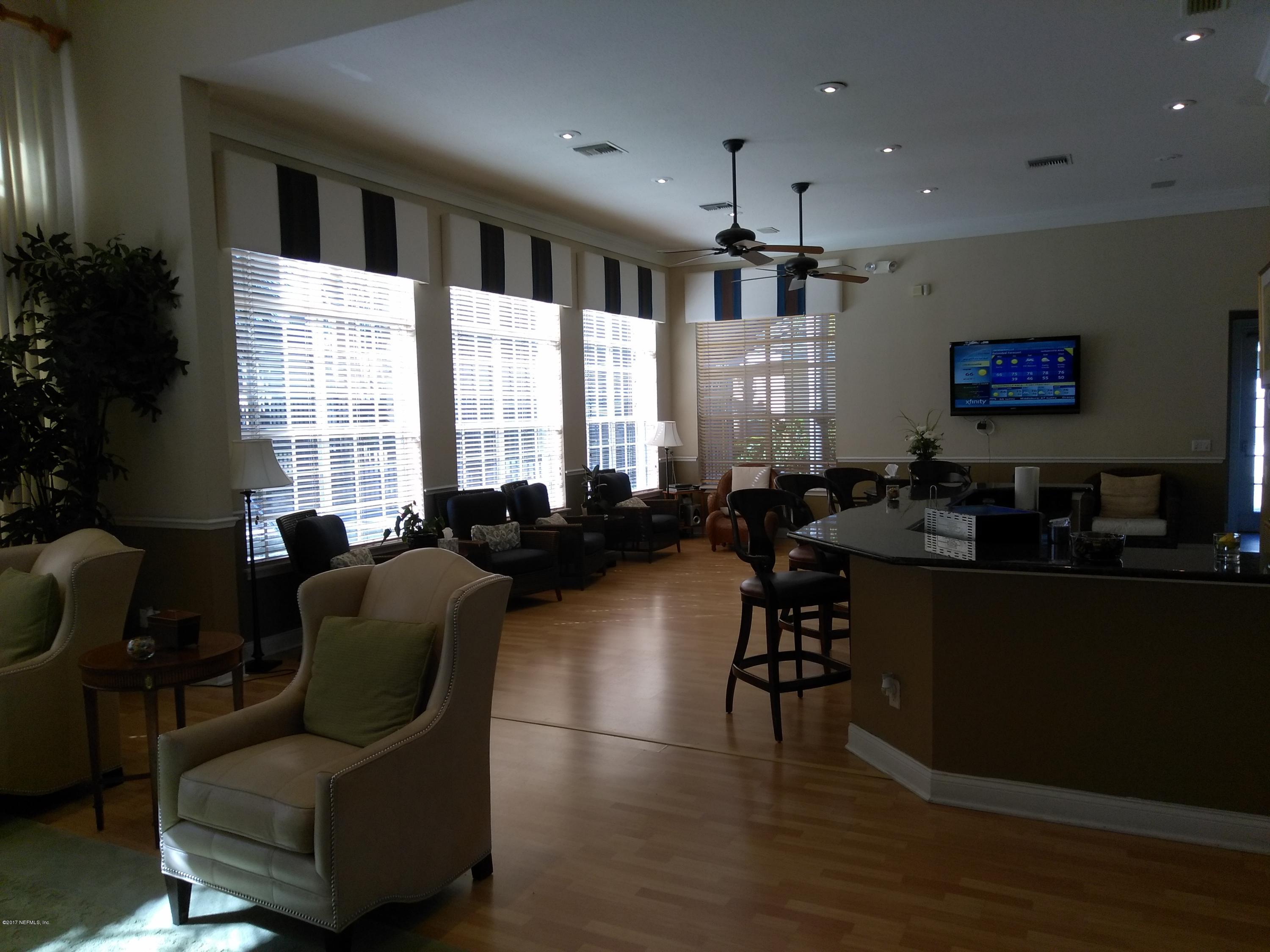 1717 County Road 220, Unit 1908 Fleming Island, FL 32003 - Photo 10 of 12 a living room with furniture and a large window