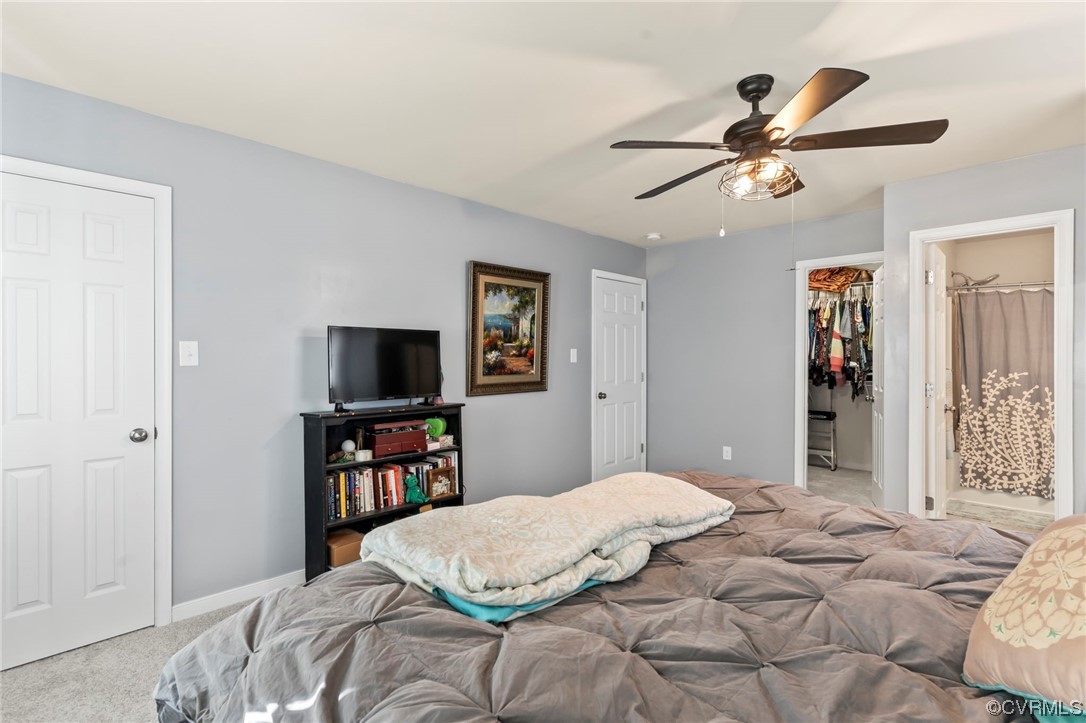 3800 Benton Avenue Richmond, VA 23222 - Photo 14 of 26 a bedroom with a large bed and a flat tv screen