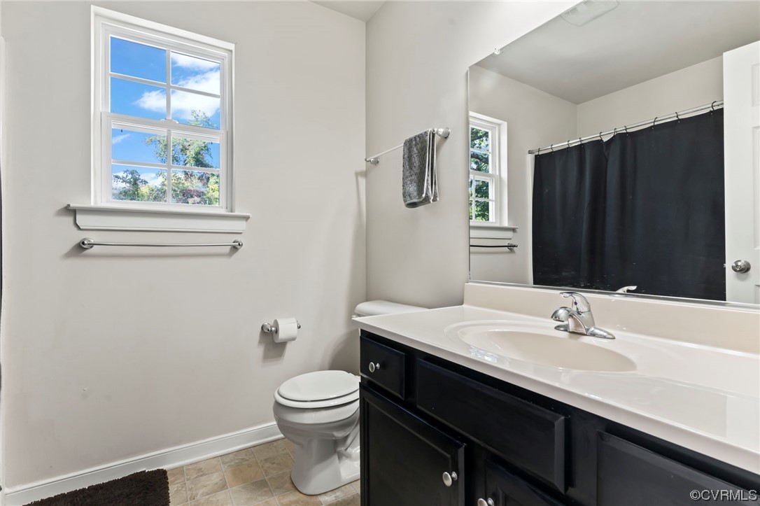 3800 Benton Avenue Richmond, VA 23222 - Photo 15 of 26 a bathroom with a sink a toilet and mirror
