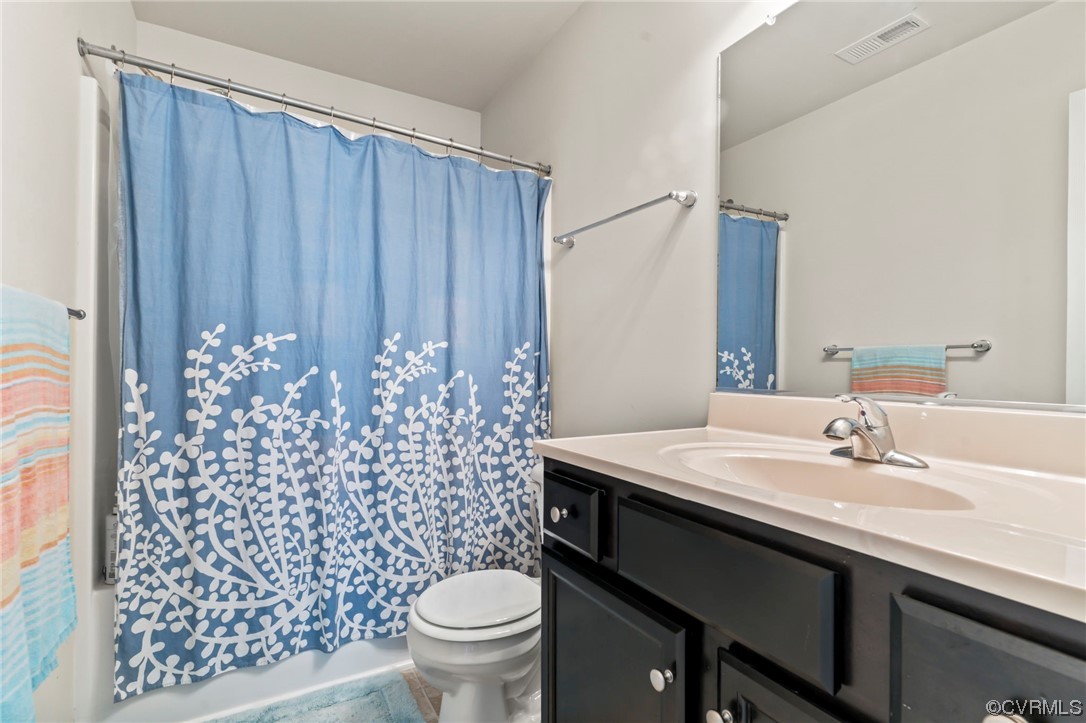3800 Benton Avenue Richmond, VA 23222 - Photo 16 of 26 a bathroom with a sink a toilet and shower curtain