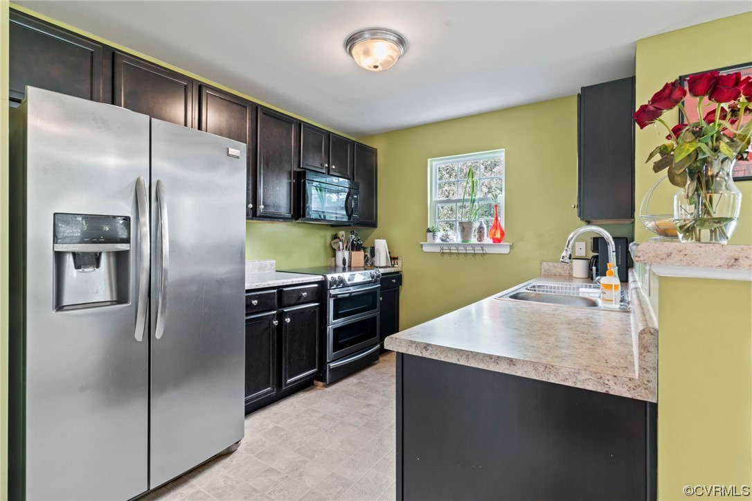 3800 Benton Avenue Richmond, VA 23222 - Photo 6 of 26 a kitchen with stainless steel appliances a refrigerator sink and stove