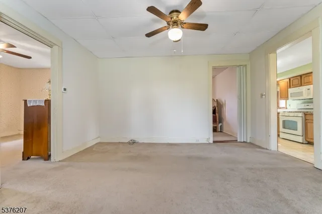 a view of a livingroom with a ceiling fan and window