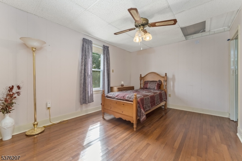6 Franklin Street Washington, NJ 07882 - Photo 25 of 38 a bedroom with a bed and wooden floor