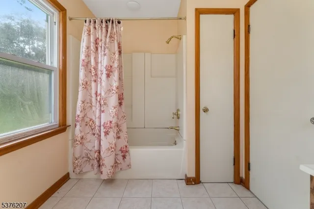 a bathroom with a bathtub and shower
