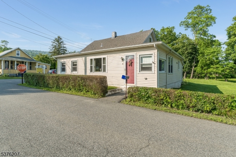 6 Franklin Street Washington, NJ 07882 - Photo 3 of 38 a front view of a house with a yard and garage