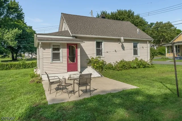 a view of a house with a yard and sitting area