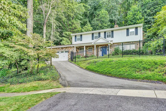 a front view of house with yard and green space