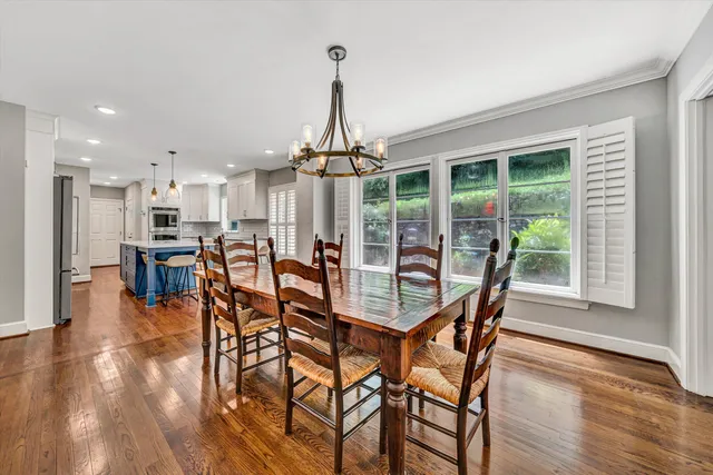 a dining room with furniture and wooden floor