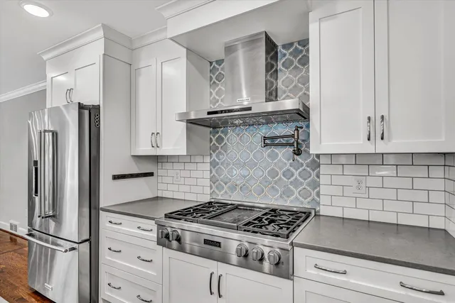 a kitchen with granite countertop stainless steel appliances and cabinets