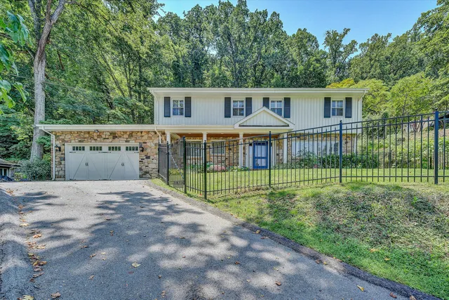 a view of a house with a backyard and a garden