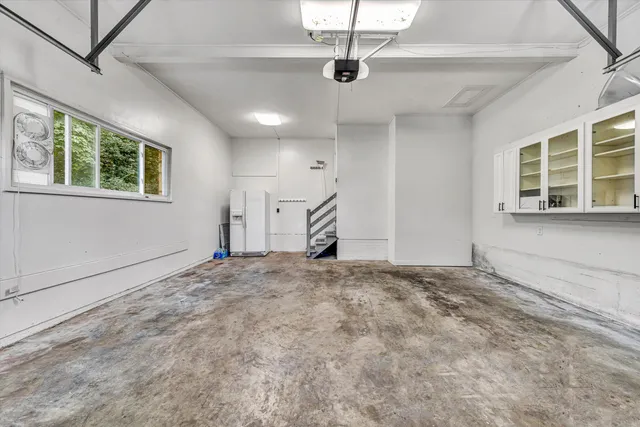 a view of a room with wooden floor and fan