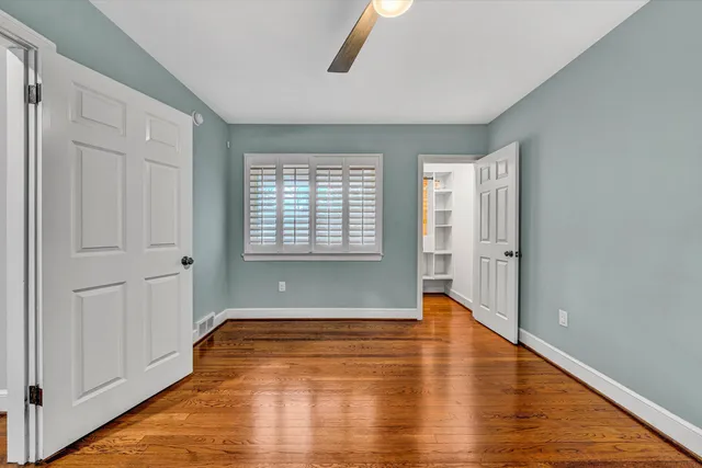 a bathroom with a granite countertop toilet a sink and a mirror