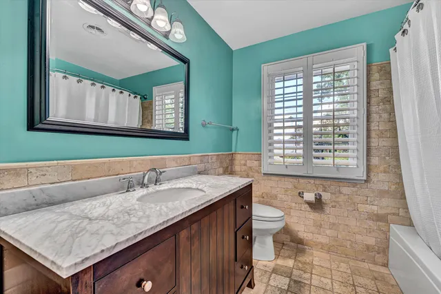 a view of a room with wooden floor and windows