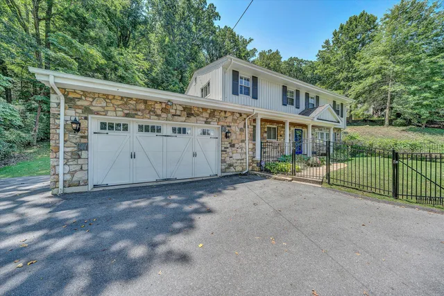 a view of a house with a wooden fence